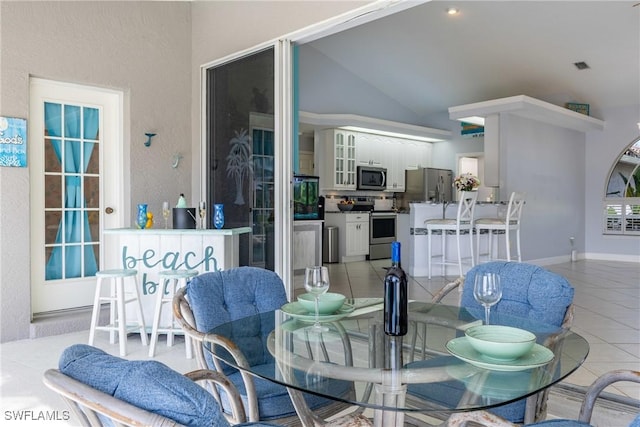 1525 SW 43rd Ter, Cape Coral, FL 33914 - dining room featuring light tile patterned floors and vaulted ceiling