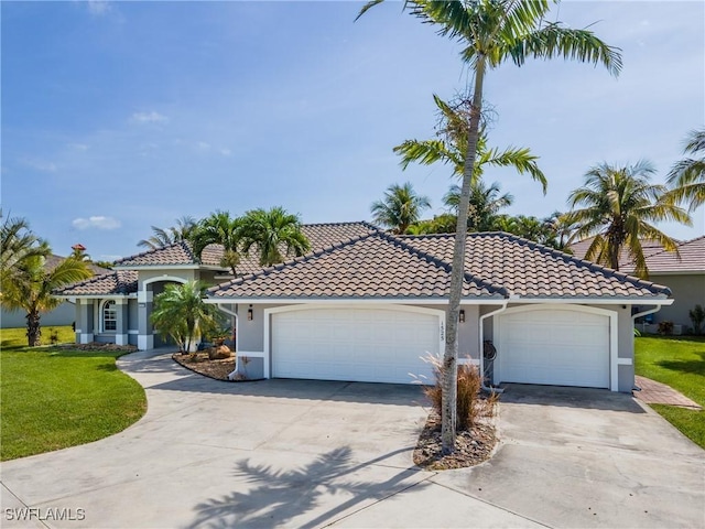 1525 SW 43rd Ter, Cape Coral, FL 33914 - mediterranean / spanish-style home with stucco siding, driveway, a front yard, and a tiled roof