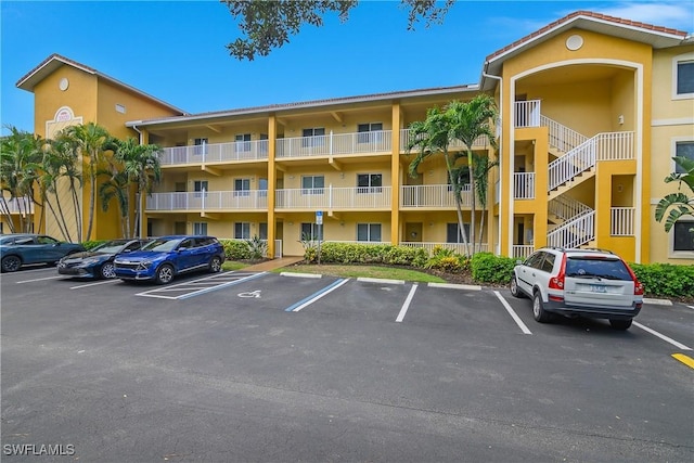 10020 Maddox Ln Unit 113, Bonita Springs, FL 34135 - view of apartment building / complex featuring uncovered parking