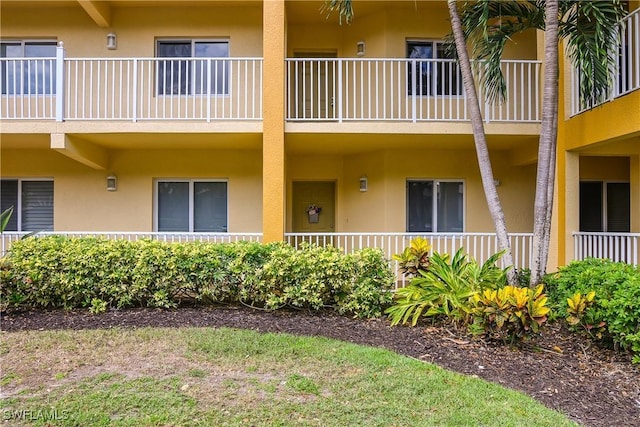10020 Maddox Ln Unit 113, Bonita Springs, FL 34135 - view of exterior entry with stucco siding