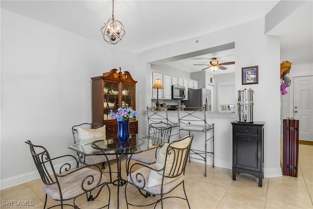 10020 Maddox Ln Unit 113, Bonita Springs, FL 34135 - dining space featuring a ceiling fan, light tile patterned flooring, and a chandelier