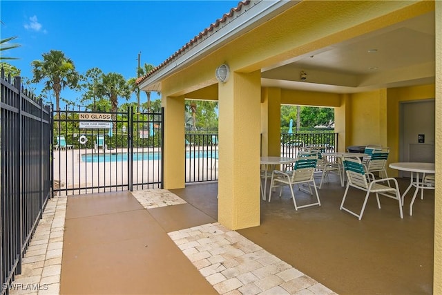 10020 Maddox Ln Unit 113, Bonita Springs, FL 34135 - view of patio / terrace featuring a community pool