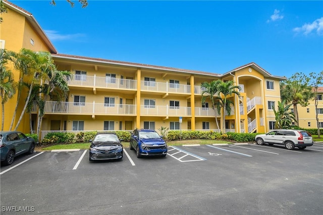 10020 Maddox Ln Unit 113, Bonita Springs, FL 34135 - view of apartment building / complex with uncovered parking