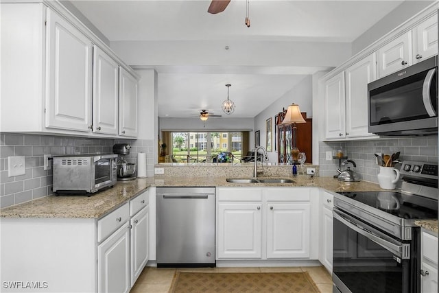 10020 Maddox Ln Unit 113, Bonita Springs, FL 34135 - kitchen featuring appliances with stainless steel finishes, ceiling fan, backsplash, and white cabinets