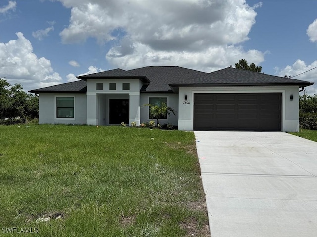 3508 17th St SW, Lehigh Acres, FL 33976 - prairie-style home featuring stucco siding, a garage, driveway, and a front lawn