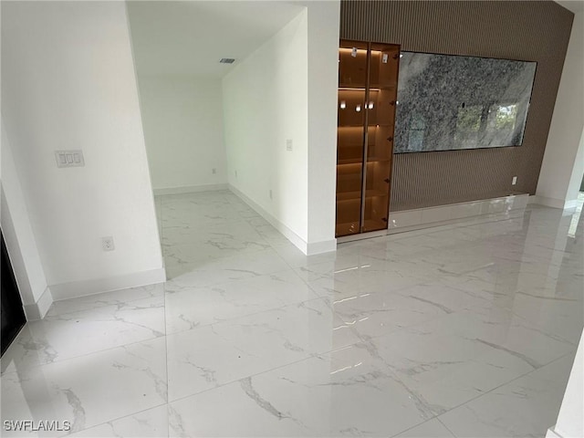 3508 17th St SW, Lehigh Acres, FL 33976 - spare room featuring marble tiled floors and baseboards