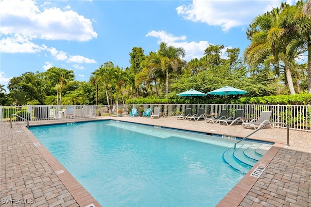28750 Trails Edge Blvd Unit 303, Bonita Springs, FL 34134 - community pool featuring a patio and view of wooded area