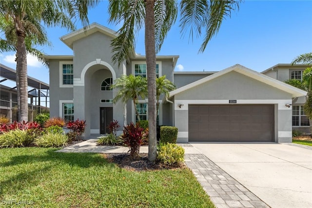 21314 Braxfield Loop, Estero, FL 33928 - view of front of home featuring stucco siding, a garage, a front lawn, and driveway