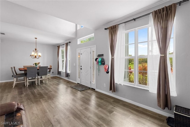 21314 Braxfield Loop, Estero, FL 33928 - foyer entrance with a chandelier, baseboards, and wood finished floors