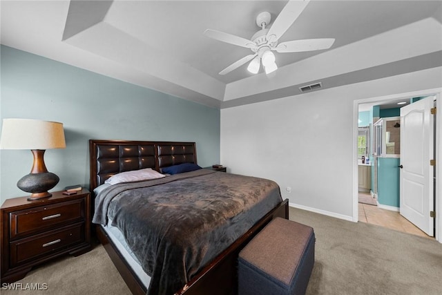 21314 Braxfield Loop, Estero, FL 33928 - bedroom with a raised ceiling, light carpet, baseboards, ceiling fan, and ensuite bathroom