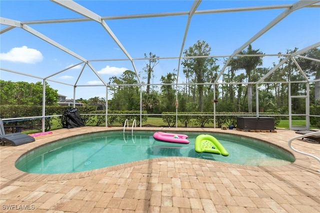 21314 Braxfield Loop, Estero, FL 33928 - outdoor pool featuring a jacuzzi, glass enclosure, and a patio area
