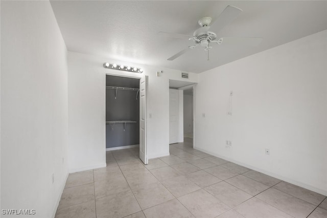 8244 Key Royal Cir Unit 615, Naples, FL 34119 - unfurnished bedroom featuring light tile patterned flooring, a closet, and a ceiling fan