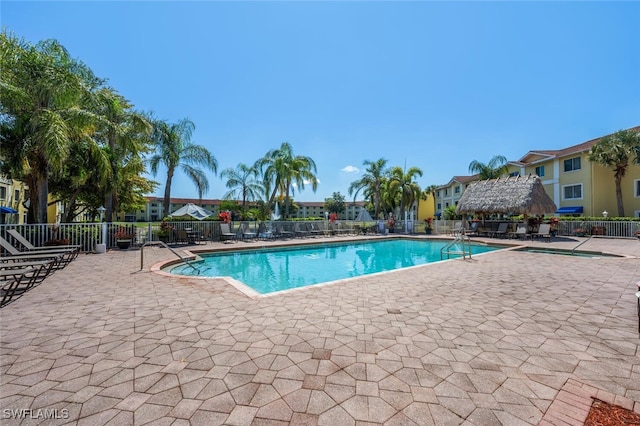 8244 Key Royal Cir Unit 615, Naples, FL 34119 - community pool featuring a patio