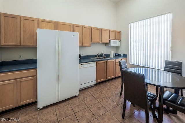 8244 Key Royal Cir Unit 615, Naples, FL 34119 - kitchen with white appliances, a high ceiling, dark countertops, and tile patterned floors