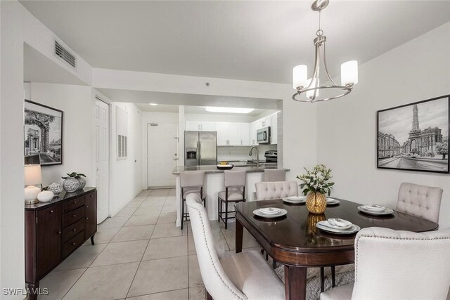 8244 Key Royal Cir Unit 615, Naples, FL 34119 - dining area with a chandelier and light tile patterned floors