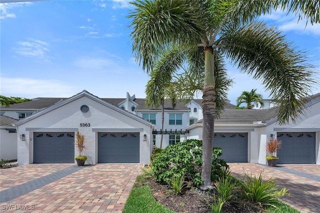 5963 Sand Wedge Ln Unit 203, Naples, FL 34110 - traditional-style house featuring stucco siding, a garage, and decorative driveway