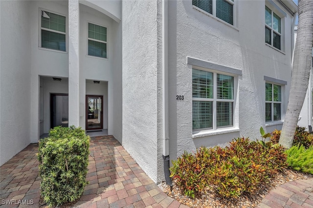5963 Sand Wedge Ln Unit 203, Naples, FL 34110 - doorway to property featuring stucco siding