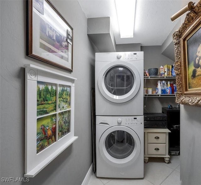 5963 Sand Wedge Ln Unit 203, Naples, FL 34110 - washroom featuring stacked washing machine and dryer and light tile patterned flooring