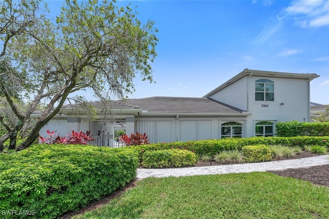 5963 Sand Wedge Ln Unit 203, Naples, FL 34110 - view of property exterior featuring a tiled roof and stucco siding