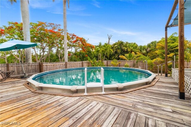 5228 Stringfellow Rd, Saint James City, FL 33956 - view of swimming pool featuring a wooden deck and a fenced backyard