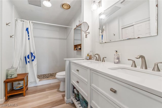 5228 Stringfellow Rd, Saint James City, FL 33956 - full bathroom with a shower with curtain, double vanity, and wood finished floors
