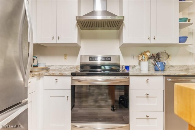5228 Stringfellow Rd, Saint James City, FL 33956 - kitchen featuring stainless steel appliances, wall chimney range hood, open shelves, white cabinetry, and light stone counters