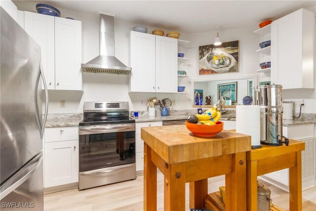 5228 Stringfellow Rd, Saint James City, FL 33956 - kitchen with appliances with stainless steel finishes, open shelves, wall chimney exhaust hood, and light wood-style flooring