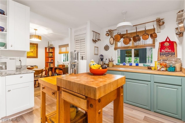 5228 Stringfellow Rd, Saint James City, FL 33956 - kitchen featuring open shelves, white cabinets, and light wood-type flooring