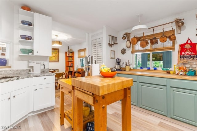 5228 Stringfellow Rd, Saint James City, FL 33956 - kitchen with white cabinetry, light wood-type flooring, and light countertops