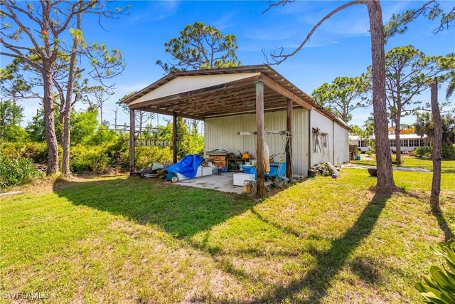 5228 Stringfellow Rd, Saint James City, FL 33956 - rear view of property featuring a lawn and a pole building