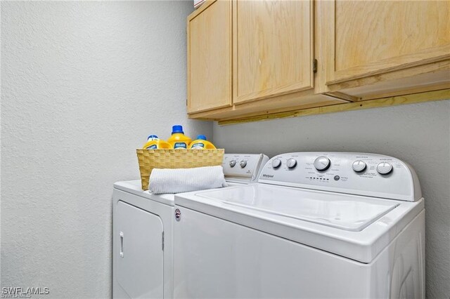 4635 Saint Croix Ln Unit 1222, Naples, FL 34109 - washroom with washing machine and clothes dryer, cabinet space, and a textured wall
