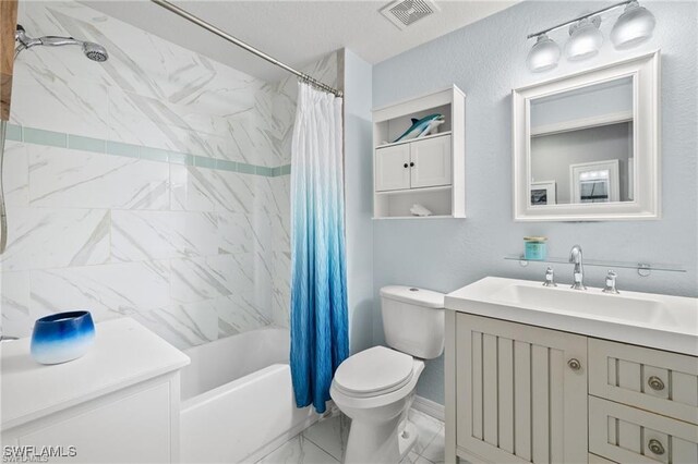 4635 Saint Croix Ln Unit 1222, Naples, FL 34109 - full bath featuring vanity, toilet, shower / tub combo with curtain, marble finish floors, and a textured ceiling