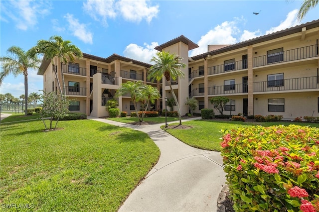 12170 Kelly Sands Way Unit 721, Fort Myers, FL 33908 - surrounding community with a yard