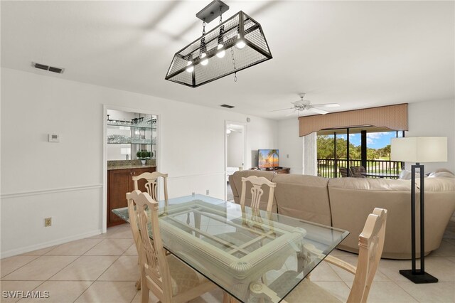 12170 Kelly Sands Way Unit 721, Fort Myers, FL 33908 - dining room featuring light tile patterned flooring, ceiling fan, and baseboards