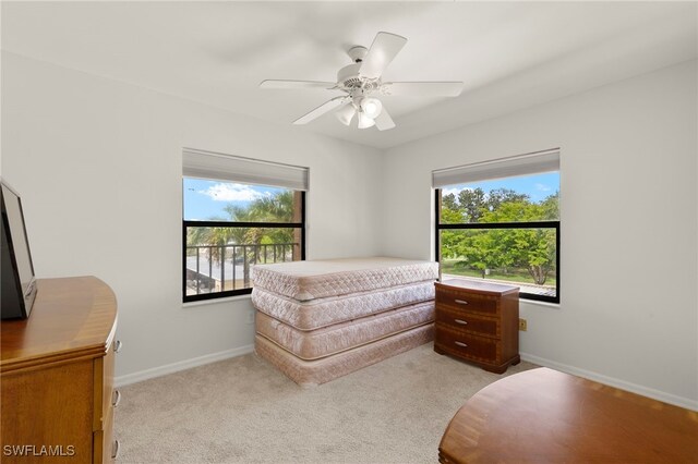 12170 Kelly Sands Way Unit 721, Fort Myers, FL 33908 - bedroom with multiple windows, light colored carpet, baseboards, and a ceiling fan