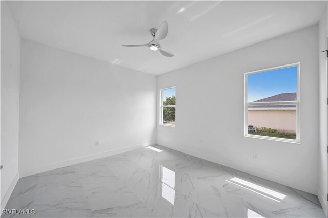 420-422 Grant Blvd, Lehigh Acres, FL 33974 - unfurnished room featuring marble look tiles and ceiling fan