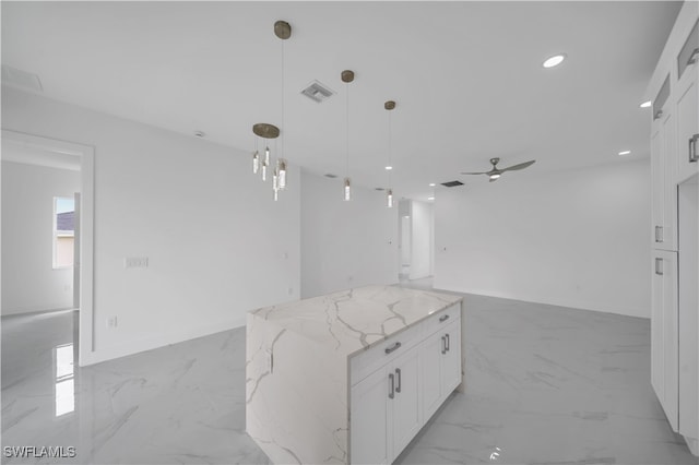 420-422 Grant Blvd, Lehigh Acres, FL 33974 - kitchen featuring white cabinets, light stone countertops, open floor plan, a ceiling fan, and decorative light fixtures