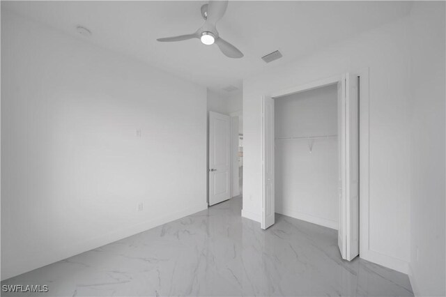 420-422 Grant Blvd, Lehigh Acres, FL 33974 - unfurnished bedroom with marble look tile flooring, a closet, and ceiling fan