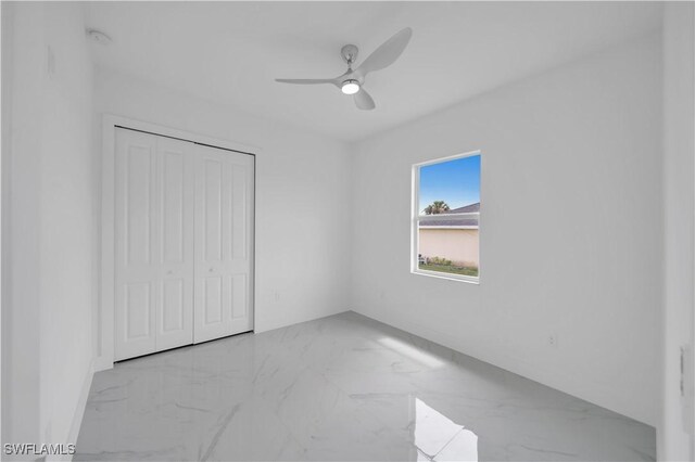 420-422 Grant Blvd, Lehigh Acres, FL 33974 - unfurnished bedroom featuring marble finish floors, a closet, and ceiling fan
