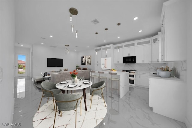 420-422 Grant Blvd, Lehigh Acres, FL 33974 - dining room featuring light marble finish floors and recessed lighting