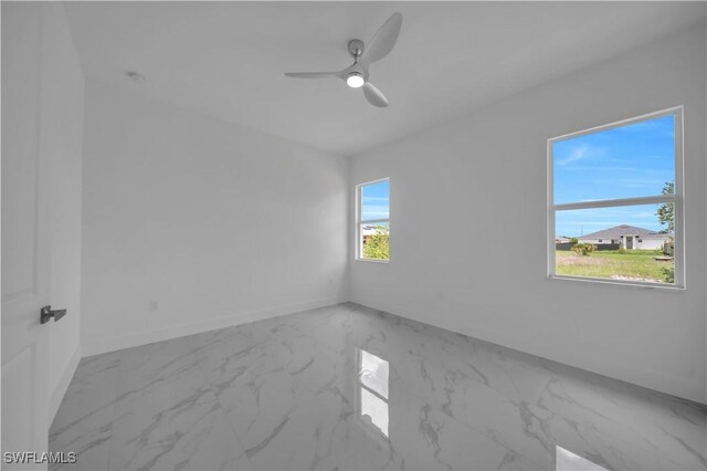 420-422 Grant Blvd, Lehigh Acres, FL 33974 - spare room featuring marble finish floors and ceiling fan