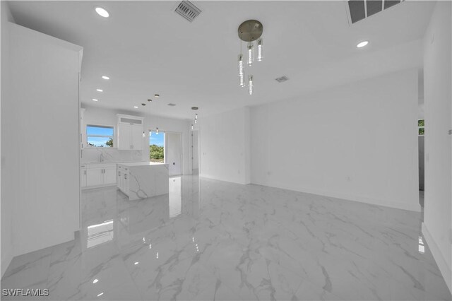 420-422 Grant Blvd, Lehigh Acres, FL 33974 - unfurnished living room with recessed lighting and light marble finish flooring