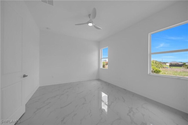 420-422 Grant Blvd, Lehigh Acres, FL 33974 - spare room featuring marble finish floors and ceiling fan