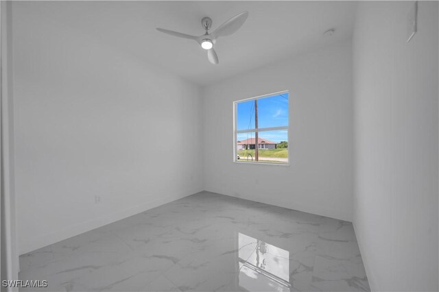 420-422 Grant Blvd, Lehigh Acres, FL 33974 - empty room with marble look tiles and ceiling fan