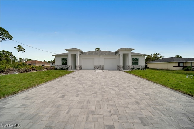 420-422 Grant Blvd, Lehigh Acres, FL 33974 - prairie-style home featuring a garage, decorative driveway, stucco siding, and a front yard