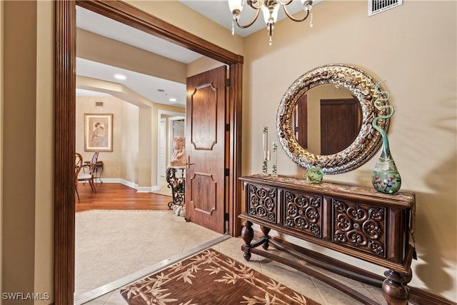 6021 Silver King Blvd Unit 302, Cape Coral, FL 33914 - hallway featuring tile patterned floors, a chandelier, and recessed lighting