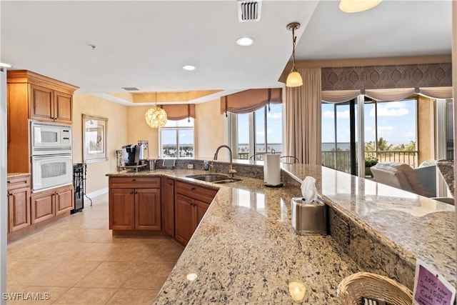 6021 Silver King Blvd Unit 302, Cape Coral, FL 33914 - kitchen with white appliances, light tile patterned floors, pendant lighting, light stone countertops, and recessed lighting