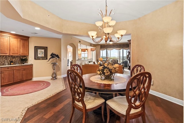 6021 Silver King Blvd Unit 302, Cape Coral, FL 33914 - dining room with dark wood-style floors, a chandelier, recessed lighting, and arched walkways