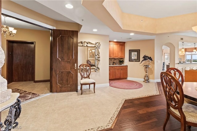 6021 Silver King Blvd Unit 302, Cape Coral, FL 33914 - dining area with a chandelier, recessed lighting, light tile patterned floors, and arched walkways