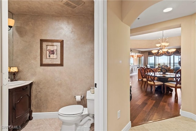 6021 Silver King Blvd Unit 302, Cape Coral, FL 33914 - bathroom with vanity, a chandelier, and wood finished floors